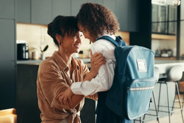 mom embracing her child on first day of school